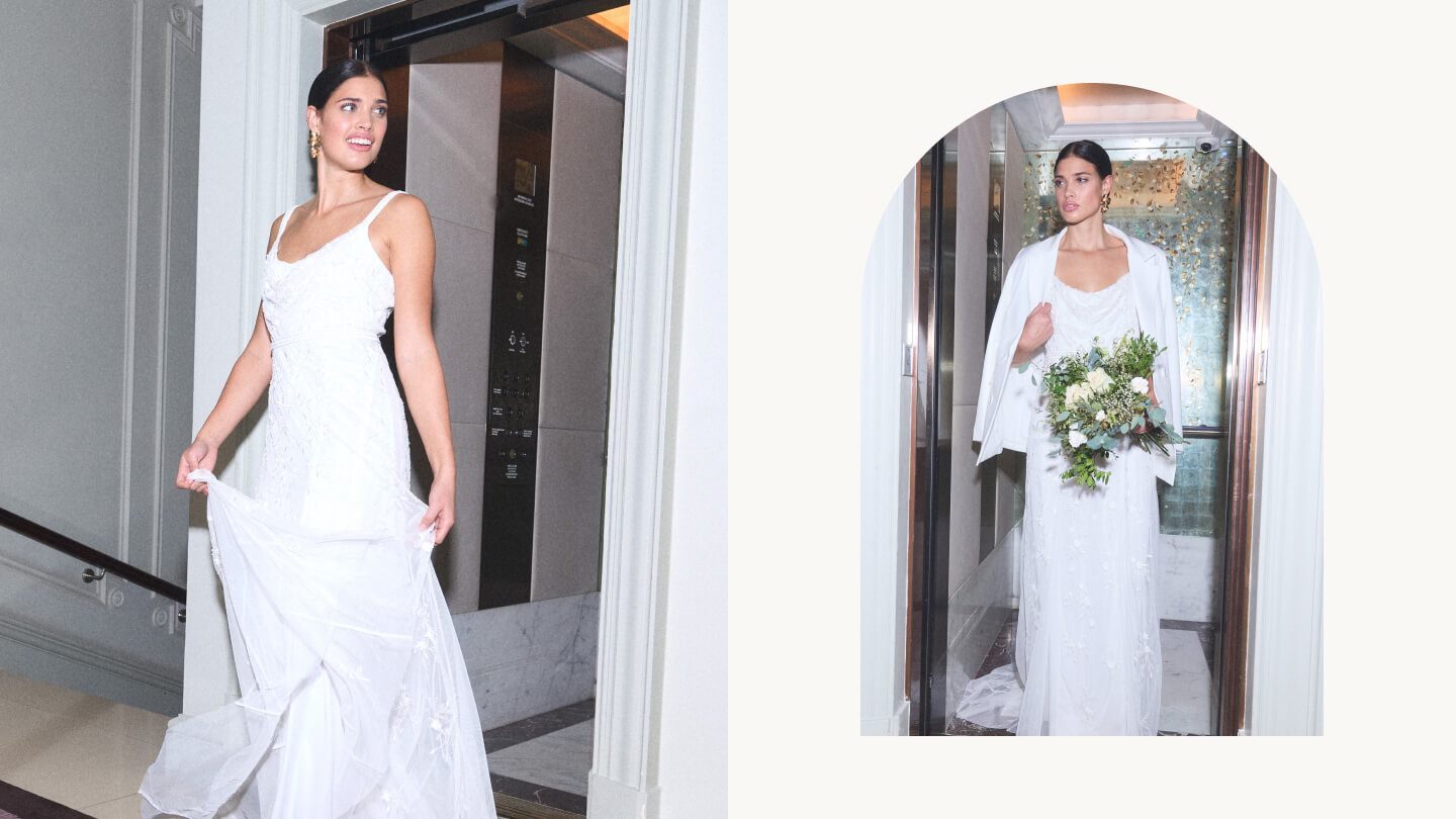 Bride walking out of hotel lift in white slip dress and white tailored jacket